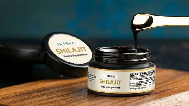 A jar of Herbius Pure Shilajit dietary supplement with a golden scoop, showcasing the natural, potent shilajit resin.