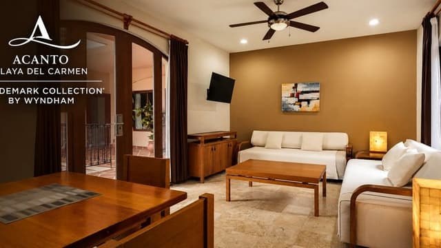 Living room and dining area in a suite at Acanto Hotel Playa del Carmen.