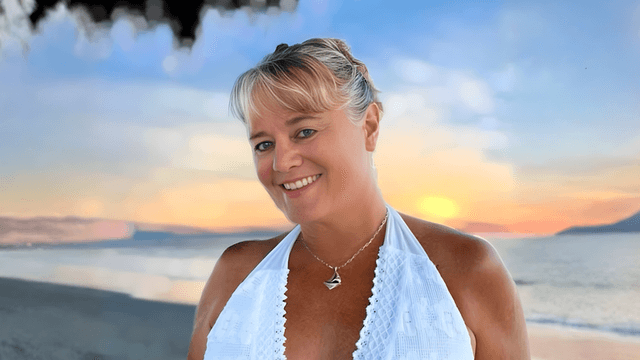 "Alison Gieschen, The Nautical Novelist, standing on a beach at sunset, exemplifying adventure, storytelling, and personal reinvention."