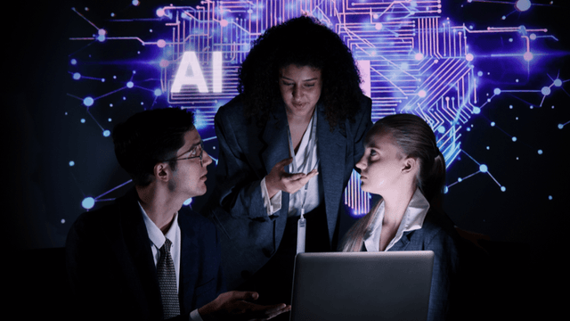 Business professionals collaborating in front of an AI technology display with a laptop.