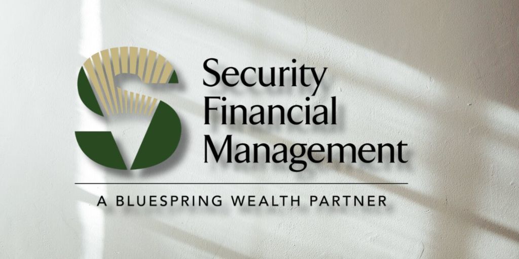 Security Financial Management logo on wall with “A Bluespring Wealth Partner” tagline and soft window light shadows.