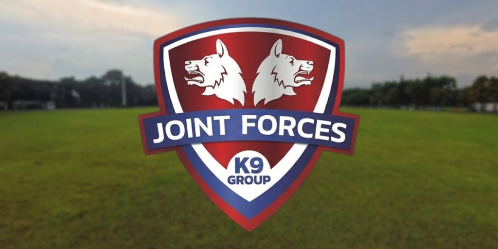 Joint Forces K9 Group logo displayed over a grassy training field.