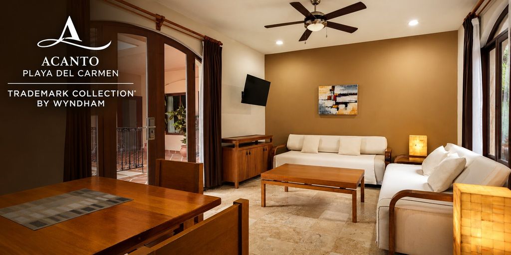 Living room and dining area in a suite at Acanto Hotel Playa del Carmen.