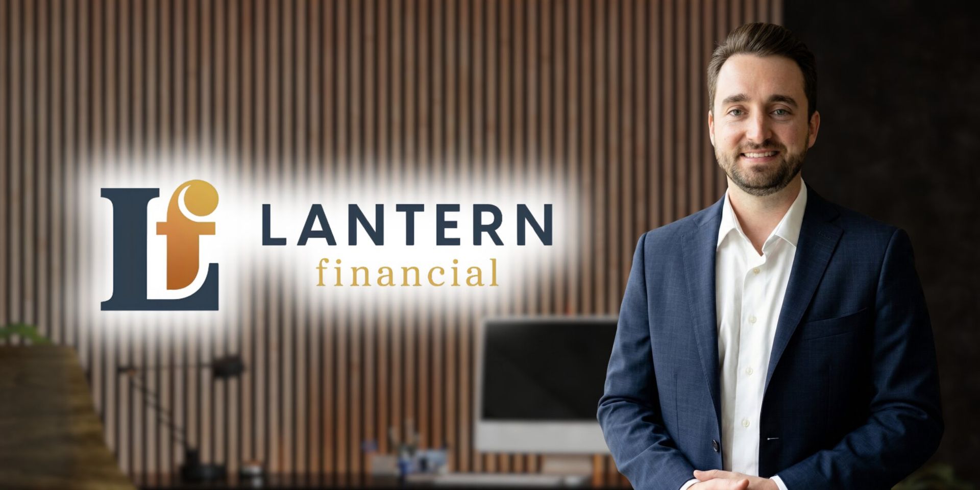 Andrew Kinder of Lantern Financial stands beside company logo in office, featured in Social Security retirement planning article.
