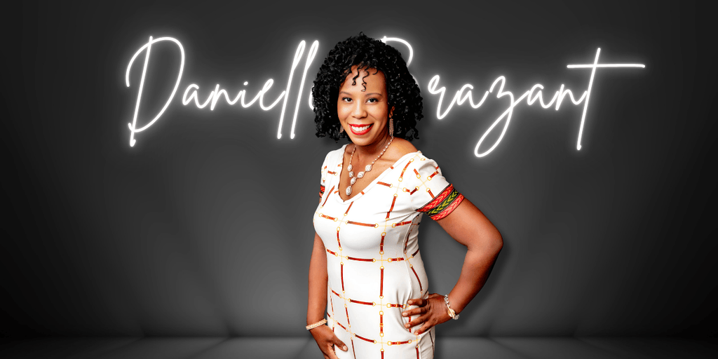 Danielle Brazant smiles in front of neon sign with her name at a photo shoot.