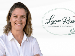 Woman smiling in a white shirt with a logo for Lynn Ross Support & Growth
