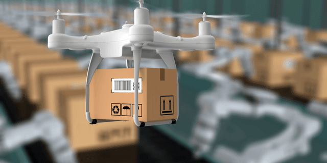 A drone carrying a package above a warehouse filled with stacked boxes