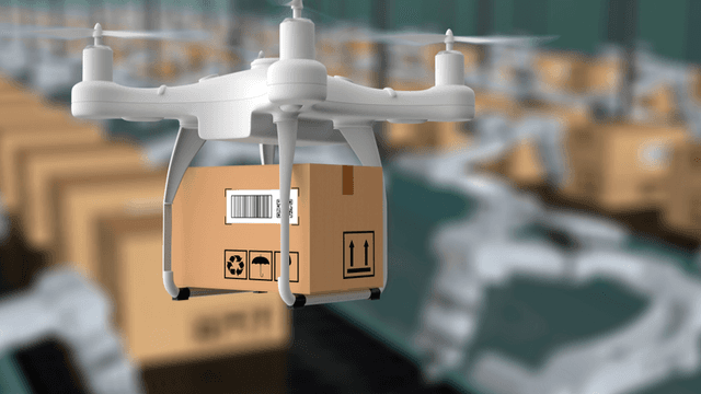 A drone carrying a package above a warehouse filled with stacked boxes