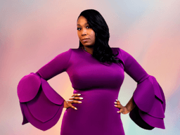 Woman in a purple dress with dramatic bell sleeves posing confidently against a soft background