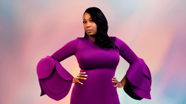 Woman in a purple dress with dramatic bell sleeves posing confidently against a soft background