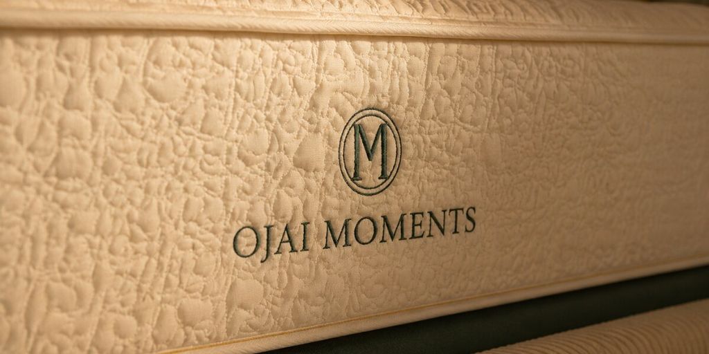 Close-up of Ojai Moments mattress with embroidered logo, highlighting premium materials and luxury construction.