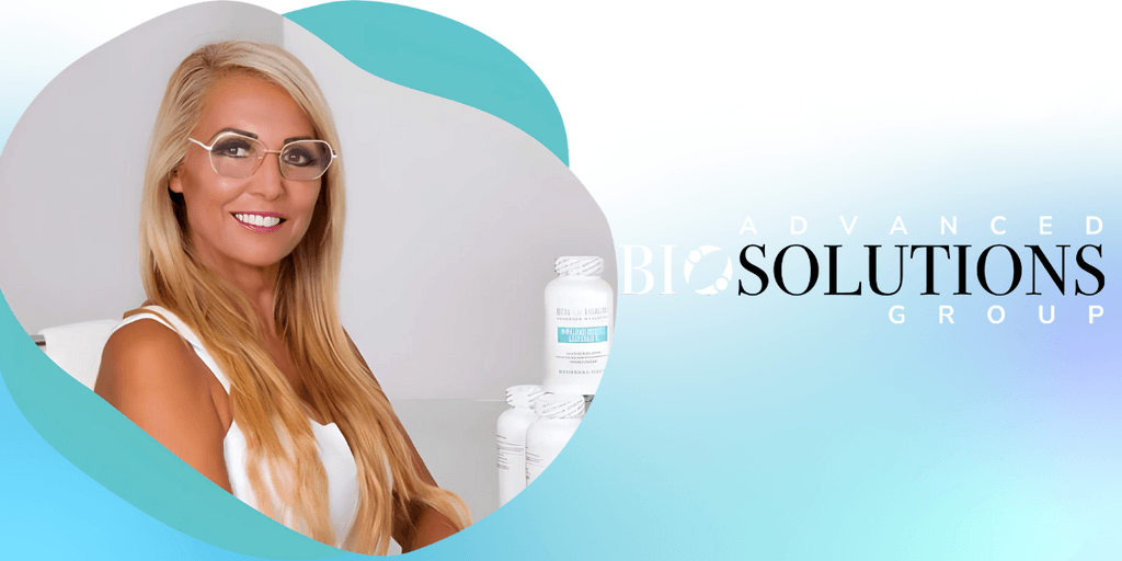 Dr. Beran Parry, founder of Advanced Bio Solutions Group, smiling confidently with natural health products in the background.