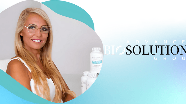 Dr. Beran Parry, founder of Advanced Bio Solutions Group, smiling confidently with natural health products in the background.