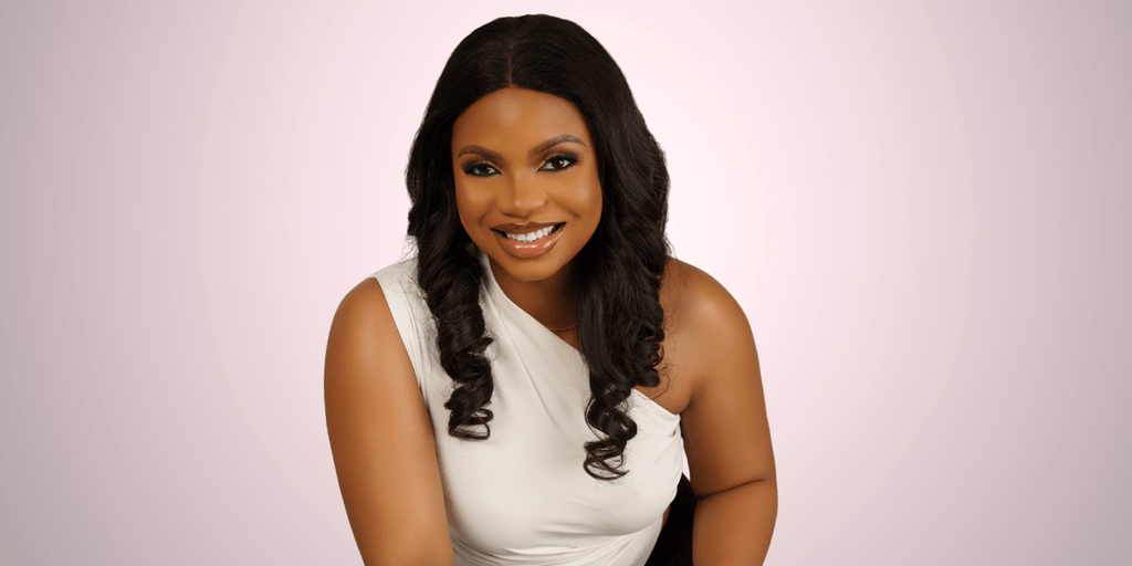 Ruth Aragbada, smiling confidently in a white top, embodies strength and transformation through her holistic wellness brand, Cura Mind Experience.