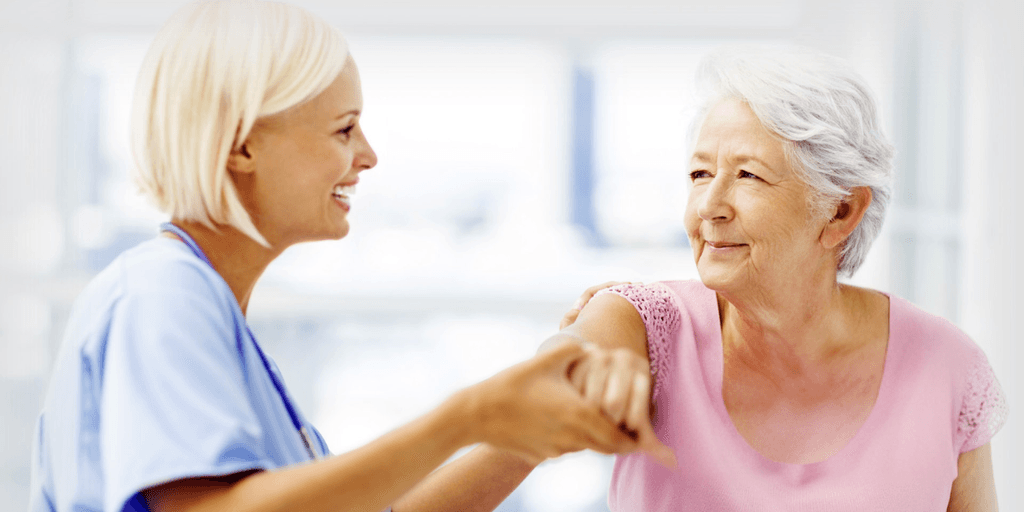 Dr. Chakalos providing compassionate care to a patient, reflecting his holistic approach to chiropractic treatment.