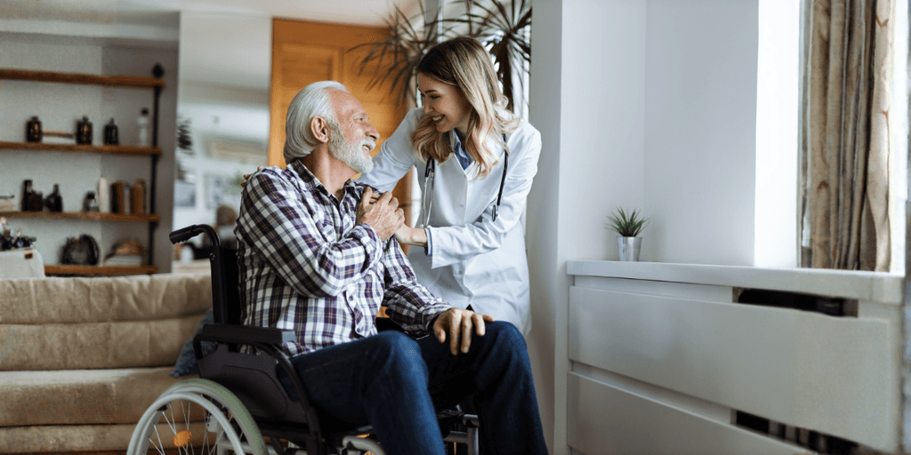 Caregiver offering compassionate support to an elderly man in a wheelchair, symbolizing the importance of healthcare and living benefits.