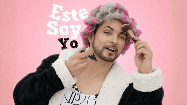John Paul Padilla, wearing a robe and curlers, applies makeup and holds a razor, embodying his self-love anthem.