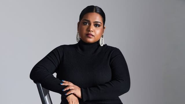 The image features Elizabeth, founder of Silver Queen, in a black turtleneck, exuding strength and confidence.