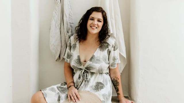 Vanessa Grace, founder of The Love Life Compass, smiling in a tropical dress, promoting soul-aligned self-care for women.