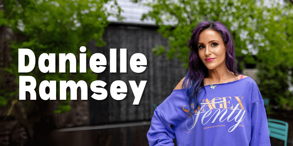 Danielle Patterson-Ramsey, founder of NTRL + NAKD Skin Spa, standing outdoors in a casual, vibrant outfit. She embodies resilience and transformation, blending military discipline, psychological insights, and holistic aesthetics to provide lasting, client-centered wellness solutions.