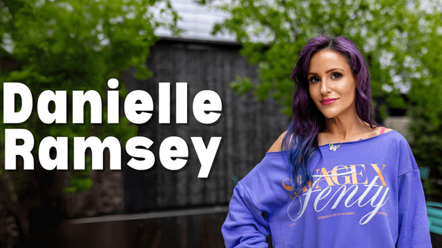 Danielle Patterson-Ramsey, founder of NTRL + NAKD Skin Spa, standing outdoors in a casual, vibrant outfit. She embodies resilience and transformation, blending military discipline, psychological insights, and holistic aesthetics to provide lasting, client-centered wellness solutions.