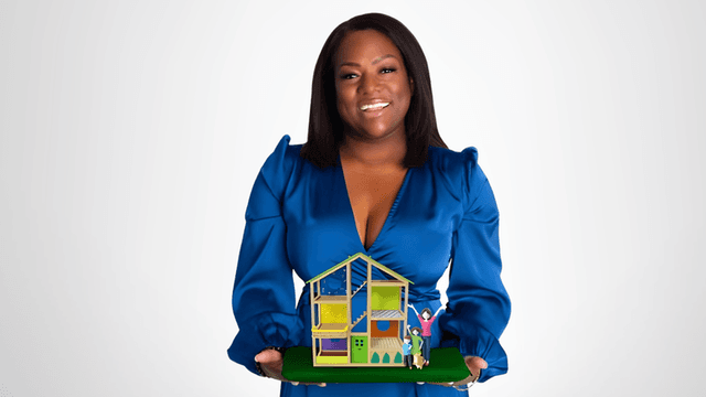 Shantel Morris, Founder of Morris Mission, holding a model house symbolizing her journey from homelessness to empowerment and advocacy.