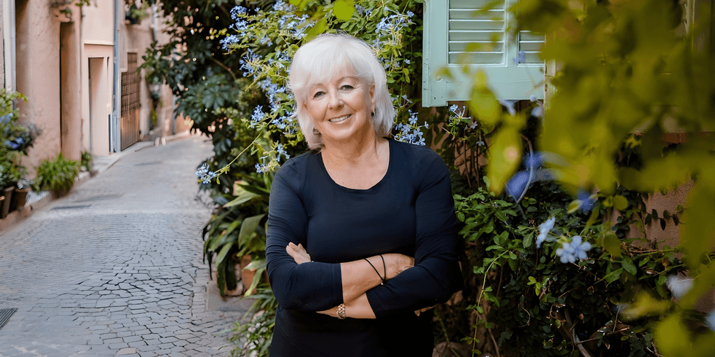 "Patricia Sands, award-winning author of women’s fiction, posing in a picturesque alley in the South of France, exuding inspiration and confidence."