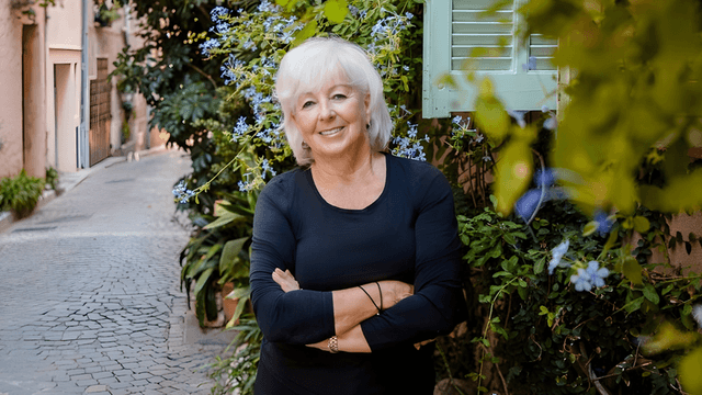 "Patricia Sands, award-winning author of women’s fiction, posing in a picturesque alley in the South of France, exuding inspiration and confidence."