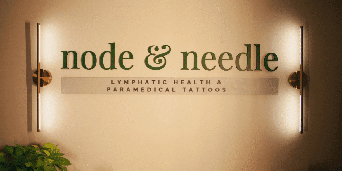 The sign for "Node & Needle" showcasing lymphatic health and paramedical tattoos, with modern lighting and greenery accents.