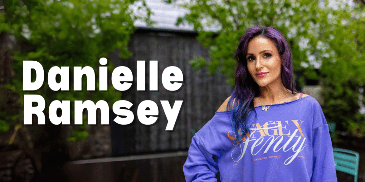 Danielle Patterson-Ramsey, founder of NTRL + NAKD Skin Spa, standing outdoors in a casual, vibrant outfit. She embodies resilience and transformation, blending military discipline, psychological insights, and holistic aesthetics to provide lasting, client-centered wellness solutions.