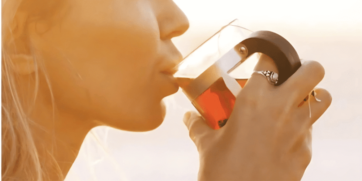 Two organic teas from Island Wellness Tea: Matcha Tea Organic and Coastal Complexion, with a green leaf tea infuser.