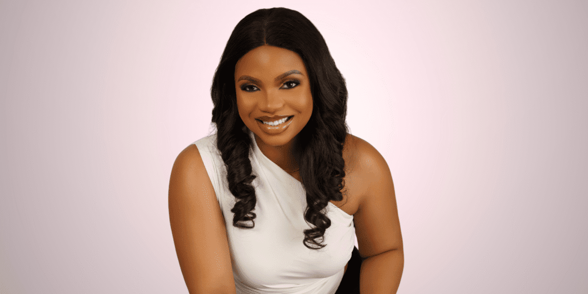 Ruth Aragbada, smiling confidently in a white top, embodies strength and transformation through her holistic wellness brand, Cura Mind Experience.