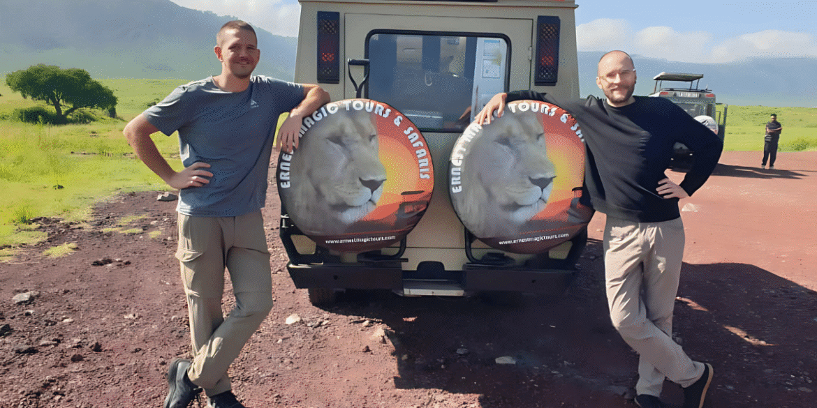 The image shows two individuals standing beside a safari vehicle with "Ernest Magic Tours & Safaris" logo, set in Tanzania.