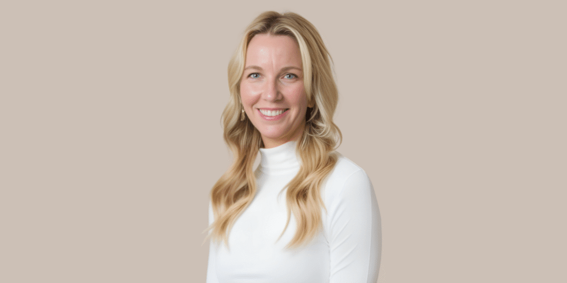 "Erin Olson, founder of Sandalfeet Ministries, smiling warmly in a white turtleneck, with soft blonde waves."