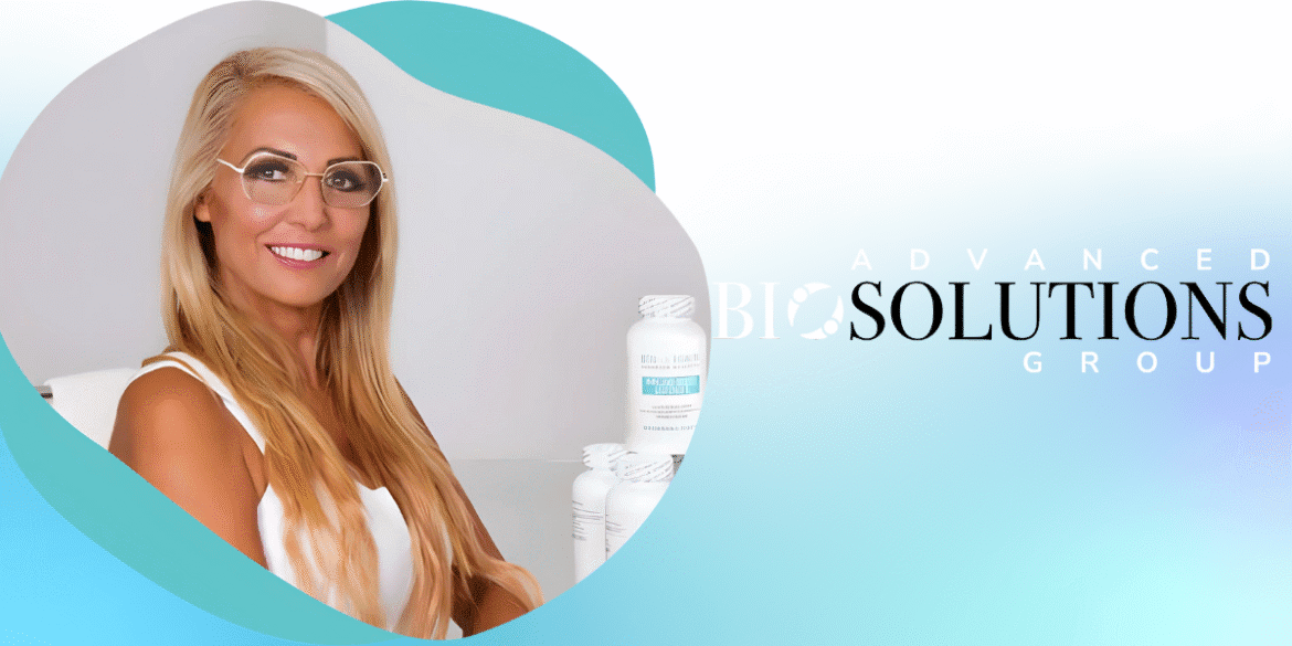 Dr. Beran Parry, founder of Advanced Bio Solutions Group, smiling confidently with natural health products in the background.
