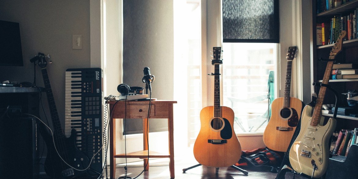 A creative music workspace featuring guitars, keyboard, and microphone, reflecting Poppy Bone's musical journey and artistic production environment.
