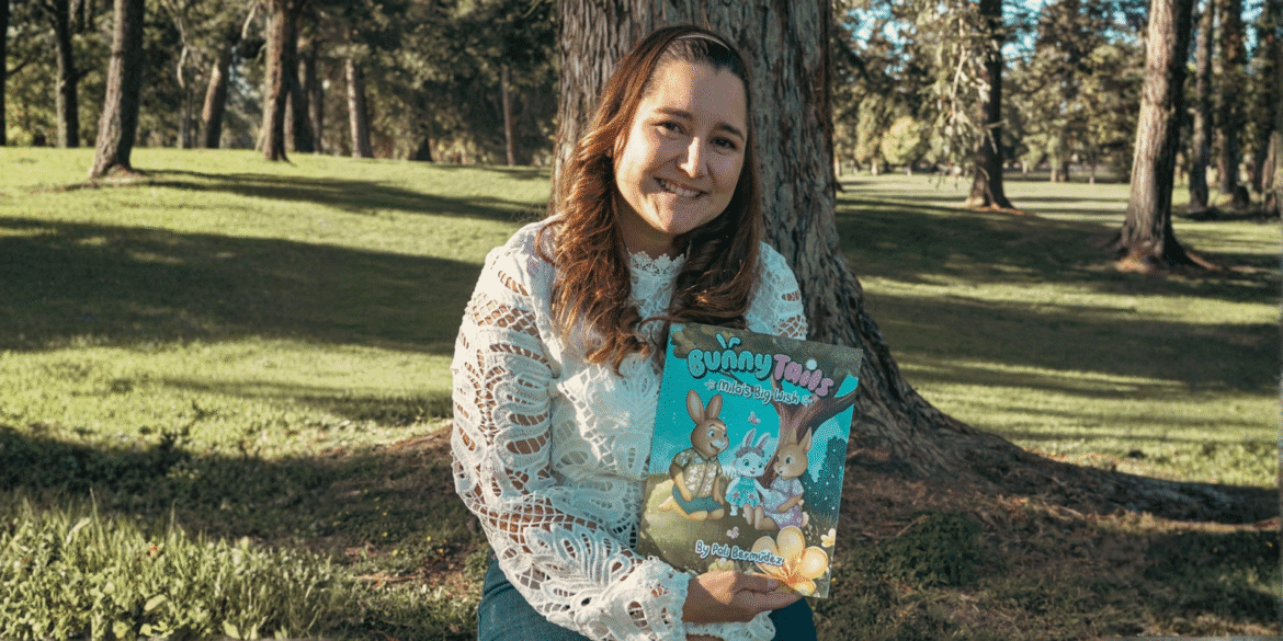 Pali Bermúdez, author and founder of Bunny Tails, holding her bilingual children's book, promoting emotional growth through storytelling.