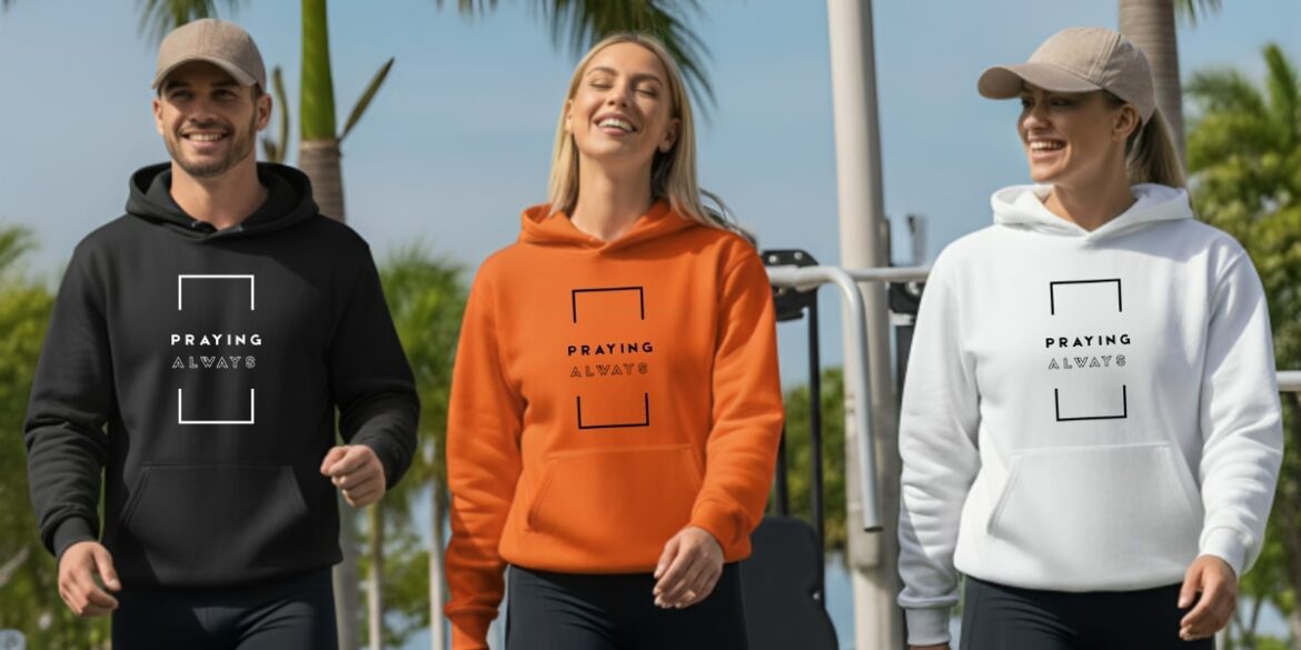Three people wearing hoodies with the "Praying Always" affirmation design in black, orange, and white outdoors.Do you like this personality?
