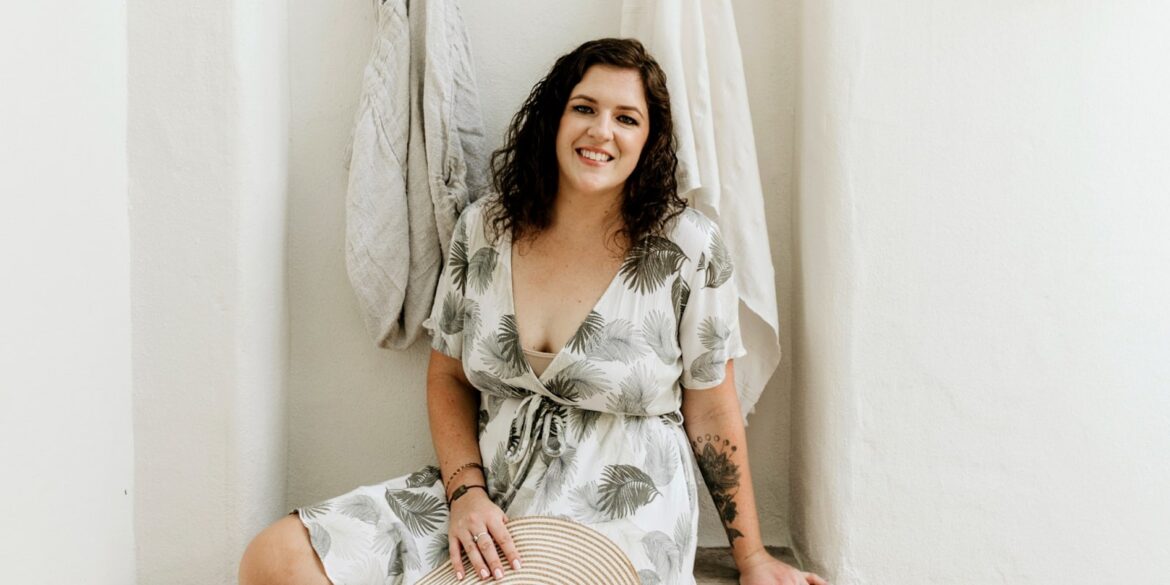 Vanessa Grace, founder of The Love Life Compass, smiling in a tropical dress, promoting soul-aligned self-care for women.