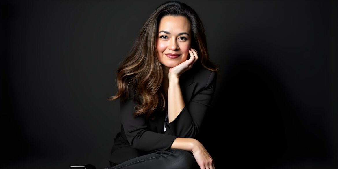 Amber Pilkington, a professional counselor, posing confidently with one hand on her chin, offering a warm smile.