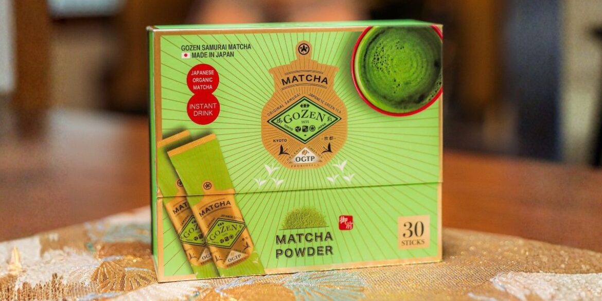 Gozen matcha powder box with individual sticks and a bowl of bright green matcha.