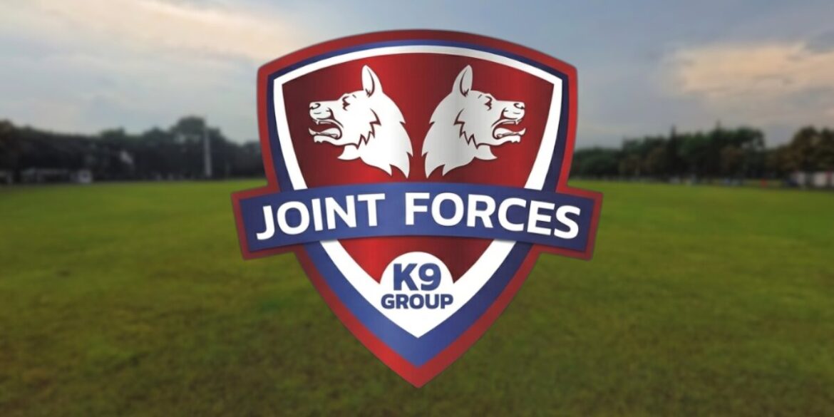 Joint Forces K9 Group logo displayed over a grassy training field.