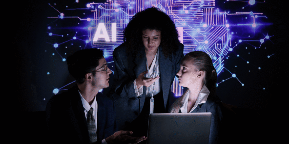 Business professionals collaborating in front of an AI technology display with a laptop.