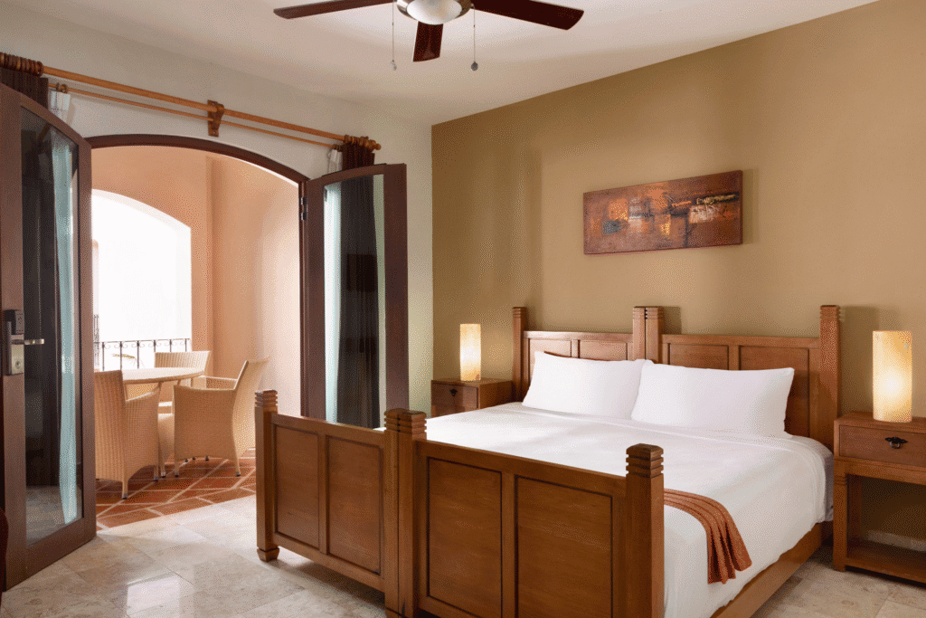 Spacious bedroom suite with private balcony at Acanto Hotel Playa del Carmen.