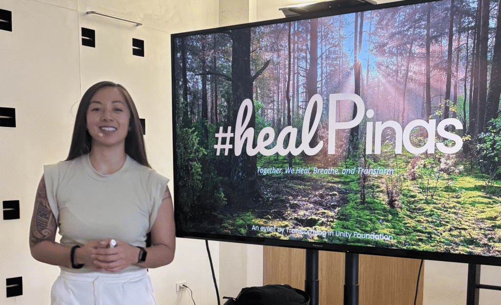 Ellie Avancy presenting the #healPinas empowerment workshop beside a presentation screen.